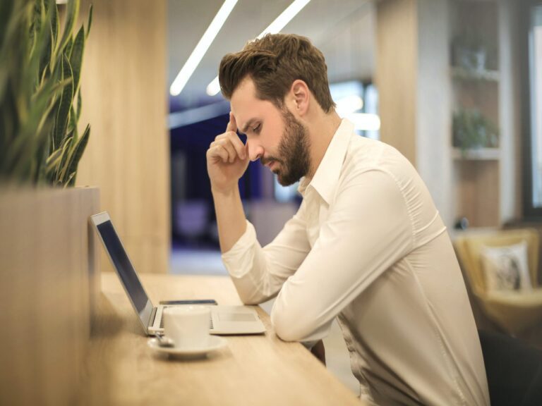 Imagem de um homem em frente a um notebook para ilustrar o texto de jornada de trabalho de 44 horas